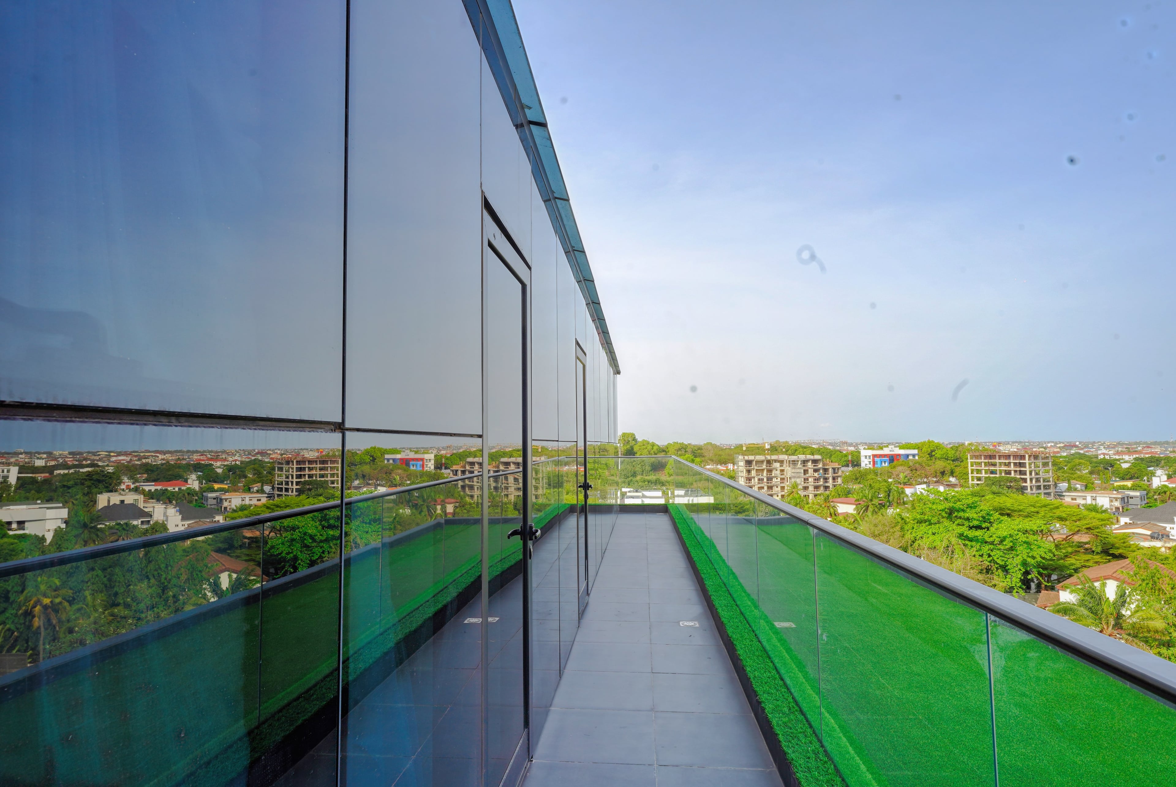A rooftop pool at dusk over Accra